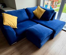 Corner sofa with footstool
