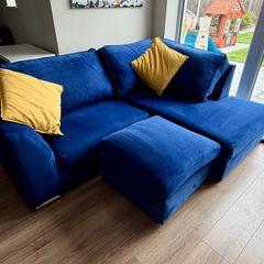 Corner sofa with footstool