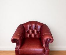 Classic Burgundy Leather Chesterfield Armchair with Brass Casters