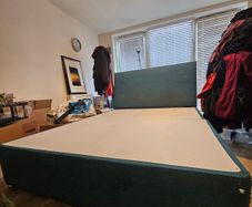 Teal fabric divan bed base with headboard