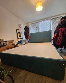 Teal fabric divan bed base with headboard
