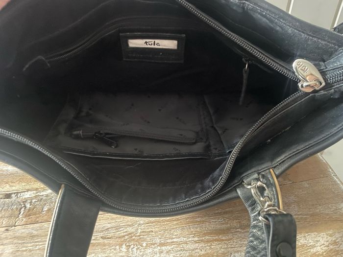 Tula black leather tote bag with a shoulder strap.