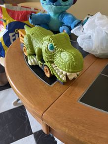 Dinosaur eating car
