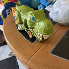 Dinosaur eating car