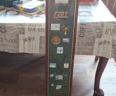 Beautiful Wooden Golf-Themed Shadow Box and Storage Unit with Shelves Cabinet, featuring a glass door front Inside the glass display panel, it showcases a vintage-style collage celebrating the history of golf,