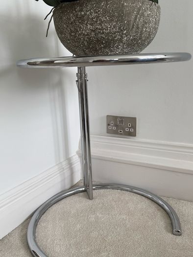 Adjustable chrome and glass side table