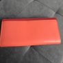 Michael Kors red and pink wallet with gold-tone MK logo. Multiple card slots and a zipped coin compartment. In perfect condition apart from some minor wear inside, which is not noticeable when using it, as shown in the photos. Image 2