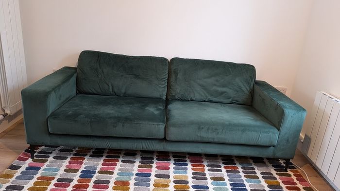 Three seater green velvet couch