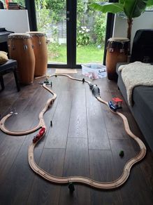 wooden train track set with wooden trains and accessories.