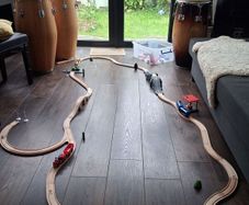 wooden train track set with wooden trains and accessories.