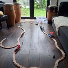 wooden train track set with wooden trains and accessories.