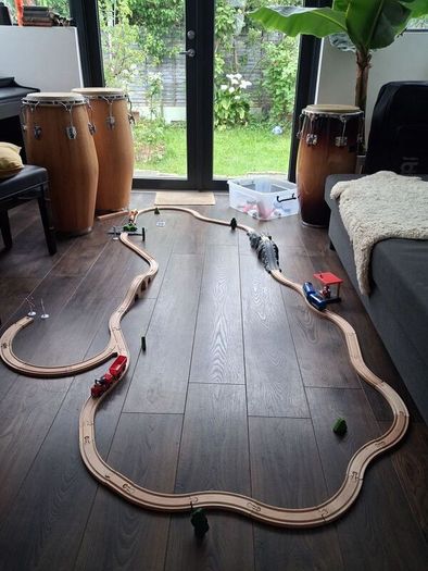 wooden train track set with wooden trains and accessories.