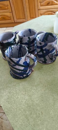 Set of 4 Irish pottery mugs featuring blue and green marbled glazes