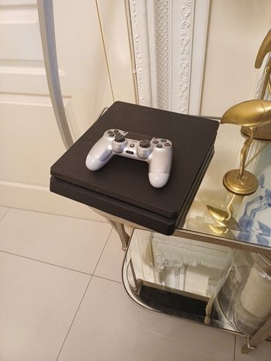 Playstation 4 slim with controller.