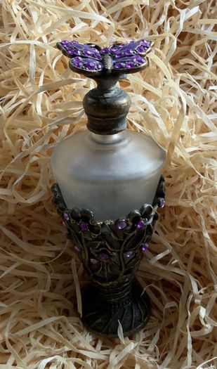 Vintage-style frosted glass perfume bottle.