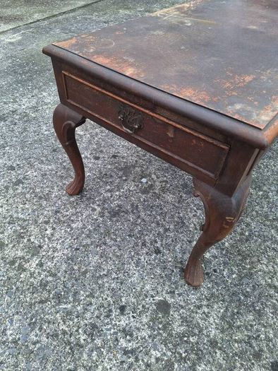 Antique wooden coffee table in need of restoration