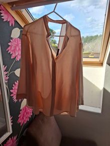 Blush coloured blouse.
