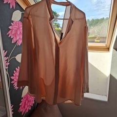 Blush coloured blouse.