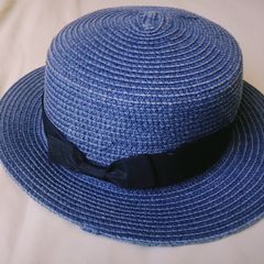 Blue woven straw boater hat with black ribbon bow, lightweight and excellent condition.