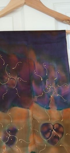 Hand painted, 100% silk scarf featuring a hand-rolled hem and custom metallic gutta detailing.