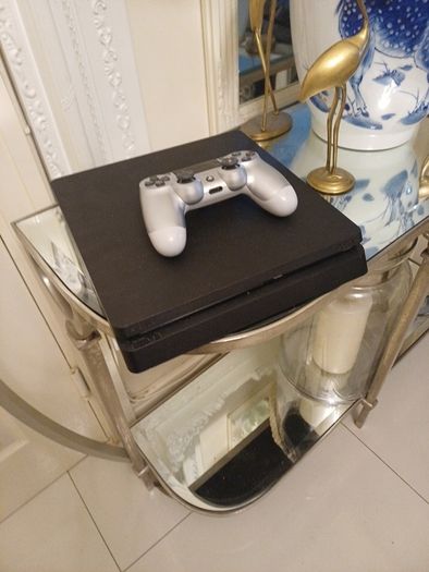 Playstation 4 slim with controller.