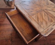 Square solid wood coffee table with drawers for storage. Rustic finish