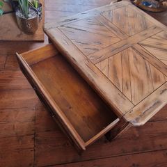 Square solid wood coffee table with drawers for storage. Rustic finish