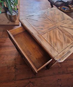 Square solid wood coffee table with drawers for storage. Rustic finish