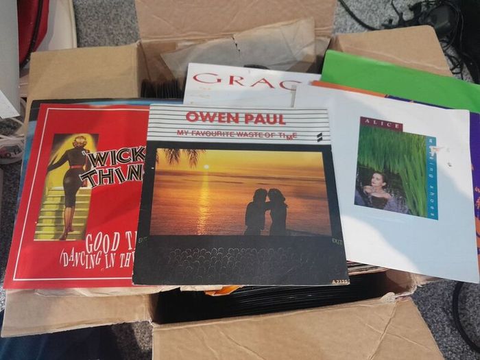 a box of 7" singles. 45 rpm vinyl records.