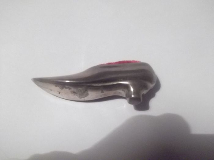 a vintage solid silver pin cushion in the shape of a shoe