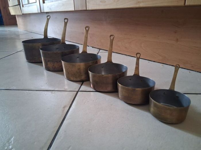 Graduated set French tinned Brass Pots and pans