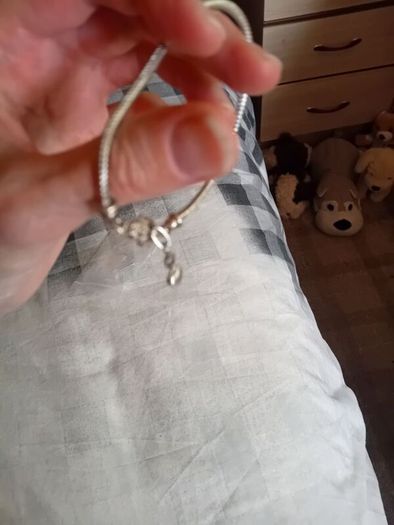 Silver toned bracelet with a heart shaped charm