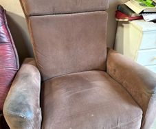 Reclining armchair with footrest