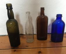 assorted Vintage glass bottles.