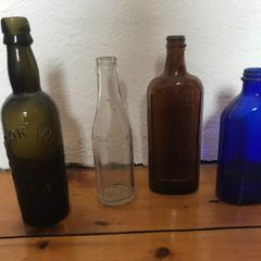 assorted Vintage glass bottles.