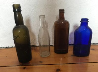 assorted Vintage glass bottles.