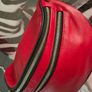 Red crossbody bag, adjustable shoulder strap. Image 2