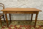 A 19th Century Victorian pine farmhouse preparation table with turned legs.