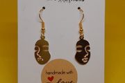 Women face charm earrings