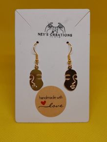 Women face charm earrings