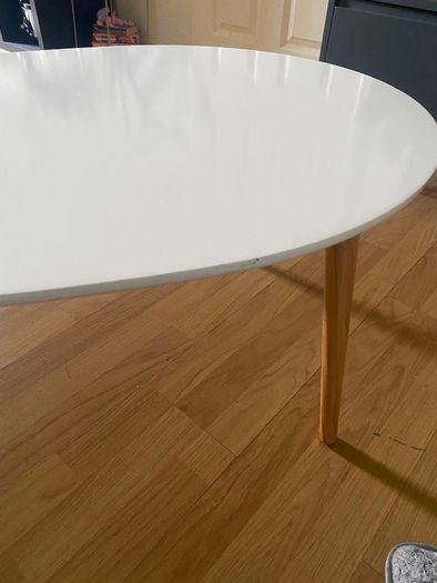 Oval white coffee table with wooden legs
