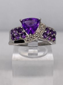 A beautiful silver ring with amethysts.