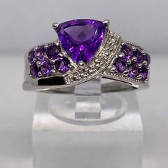 A beautiful silver ring with amethysts.