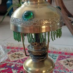 Antique petit brass oil lamp with green beaded garland