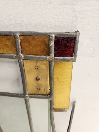Vintage leaded glass with curved brass screen .