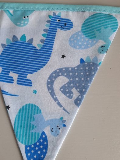 Dinosaur buntings . Blue and pink
