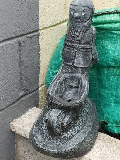 Man holding a wheelbarrow planter