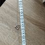 A silver bracelet with a heart-shaped pendant featuring a horse and foal's head. Image 5