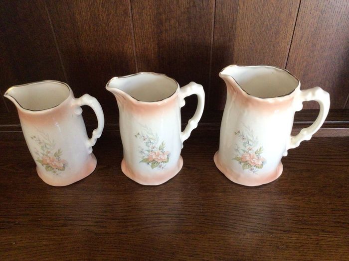 A set of 3 Large Peach Floral porcelain Graduating jugs