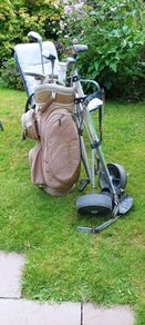 golf bag, trolley, and a couple of clubs